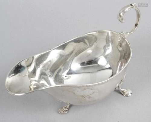 An Edwardian silver sauce boat of bellied form,