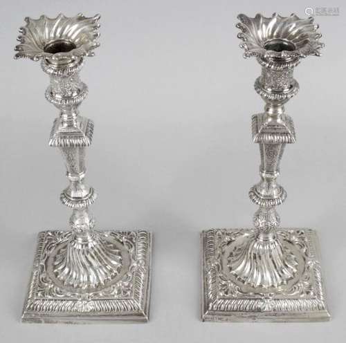 A matched pair of early George III silver candlesticks,