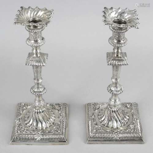 A matched pair of early George III silver candlesticks,