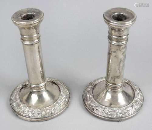 A pair of Edwardian silver mounted candlesticks,