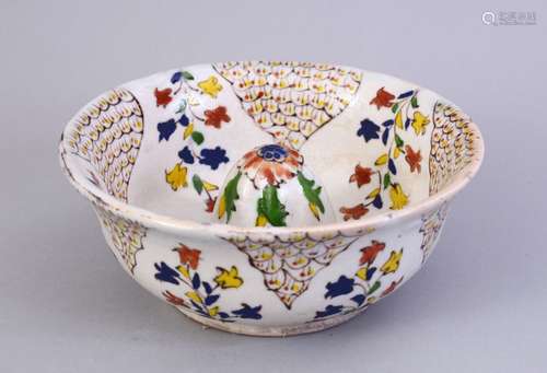 A GOOD EARLY TURKISH KUTAHYA POTTERY LEMON SQUEEZER, decorated with floral design, 14.5cm diameter.