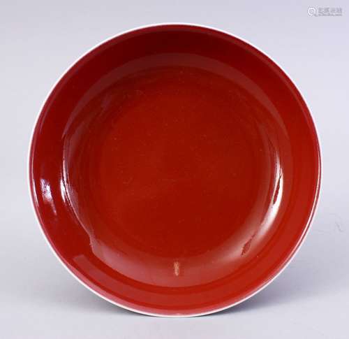 A CHINESE RED GLAZED MONOCHROME PORCELAIN DISH,the base with a four character mark and other script,