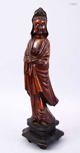 A GOOD JAPANESE MEIJI PERIOD CARVED WOOD OKIMONO OF KWANNON, stood holding a scroll, fitted to a