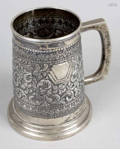 A mug marked sterling silver,