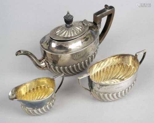 A late Victorian silver three piece bachelor tea set,