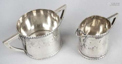 A mid-Victorian silver twin-handled sugar bowl and matching cream jug,