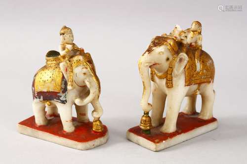 TWO INDIAN POLY CHROME CARVED MARBLE FIGURES OF ELEPHANTS AND RIDERS, both elephants in striding