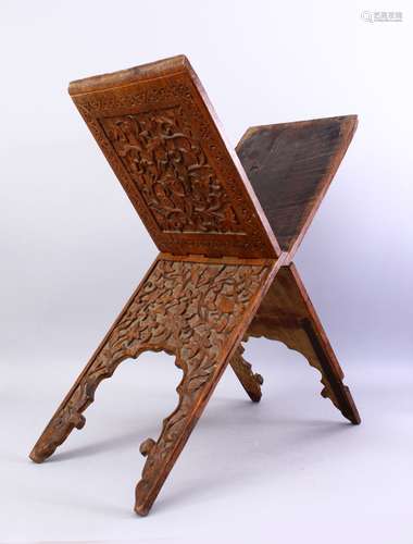 A GOOD ISLAMIC CARVED WOODEN QURAN STAND, carved with foliate decoration, closed, 76cm high x 26cm