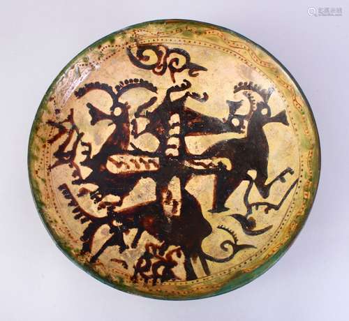 A GOOD EARLY ISLAMIC POTTERY DISH, decorated with animals, 33cm, AF