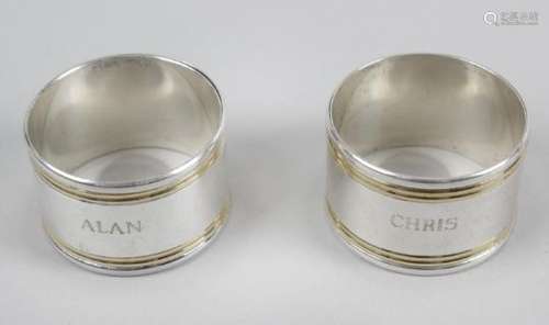 A pair of bi-colour napkin rings by Tiffany & Co, each with name engravings and reeded edge.