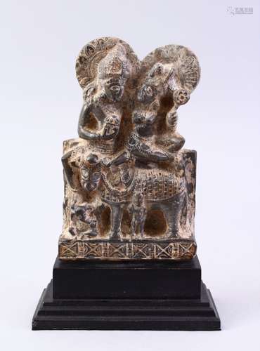 A GOOD GHANDARA CARVED STONE FIGURE, of two figures with an animal, 22cm high on stand.