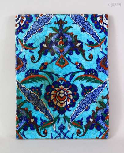 A LARGE IZNIK TURKISH POTTERY TILE, decorated with a blue ground and floral decoration, 34cm high