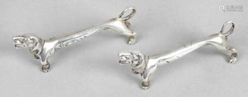 A pair of Edwardian silver novelty knife rests, each modelled as an elongated dachshund.