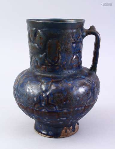 A FINE EARLY ISLAMIC BLUE GLAZED POTTERY JUG, with a moulded body, 22cm high.