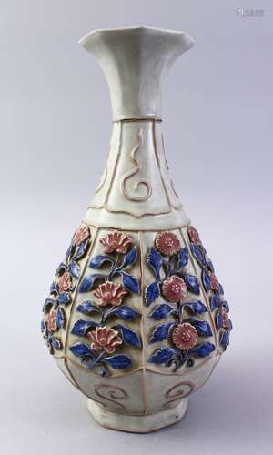 A CHINESE MING STYLE CARVED LOTUS PORCELAIN VASE, the body carved in relief to depict sprays of