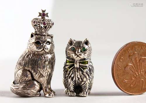 TWO CAST SILVER NOVELTY CATS with gem set eyes.