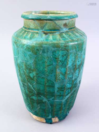 A LARGER ISLAMIC TURQUOISE GLAZED POTTERY VASE, with a ribbed body, 29cm high.