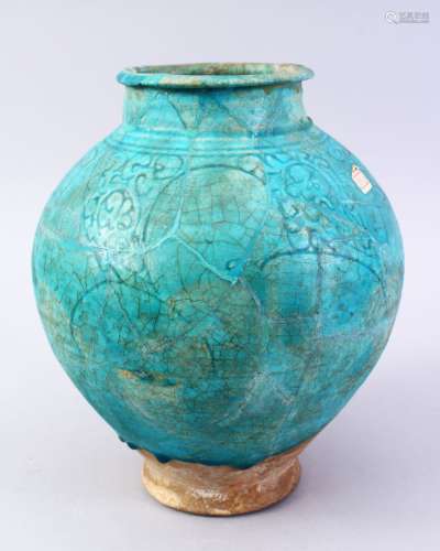 A GOOD EARLY ISLAMIC TURQUOISE GLAZED POTTERY VASE, with carved floral decoration, 27cm high.