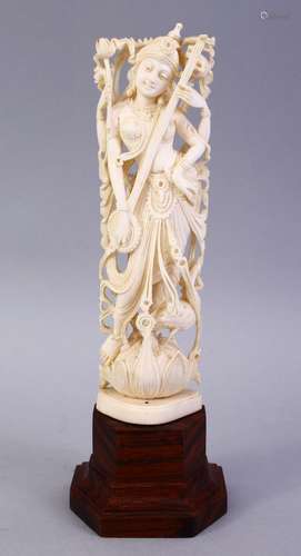 A GOOD 19TH CENTURY CARVED INDIAN IVORY FIGURE OF A DEITY, on a wooden base, 19cm.