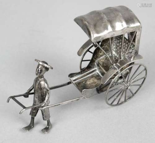 A Chinese export silver figure of a man pulling a rickshaw,