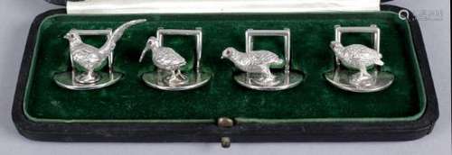 A set of four George V silver menu card holders,