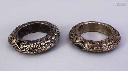 TWO ISLAMIC WHITE METAL POSS SILVER BANGLES, the untested white metal with embossed decoration, 11.