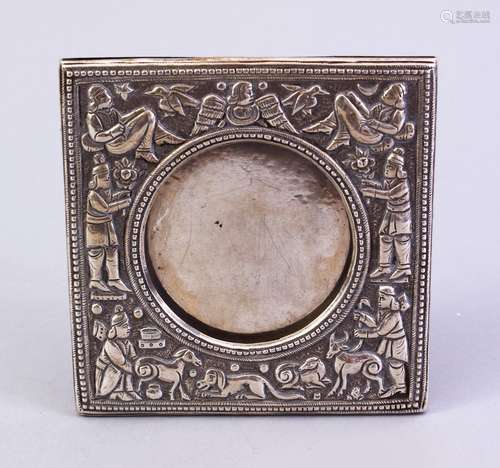 A GOOD INDIAN SILVER PHOTO FRAME AND STAND, with embossed decoration depicting figures and