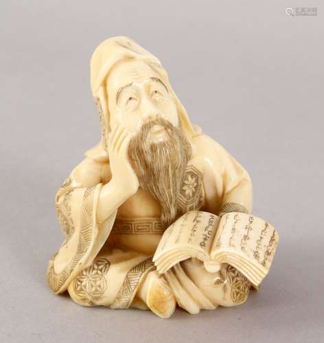 A JAPANESE MEIJI PERIOD CARVED IVORY OKIMONO OF A PRIEST, in a seated position holding his book of