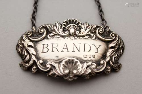 A SILVER WINE LABEL, BRANDY.