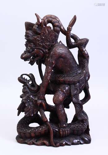 A GOOD 19TH CENTURY CHINESE CARVED HARDWOOD MYTHICAL FIGURE, carved to depict a mythical figure