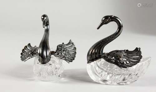 A PAIR OF SILVER AND CUT GLASS TABLE SALTS. 3ins long.