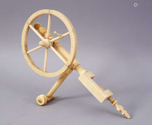 A FINE 19TH CENTURY ANGLO INDIAN CARVED IVORY SEWING IMPLEMENT, comprising of a large wheel, small