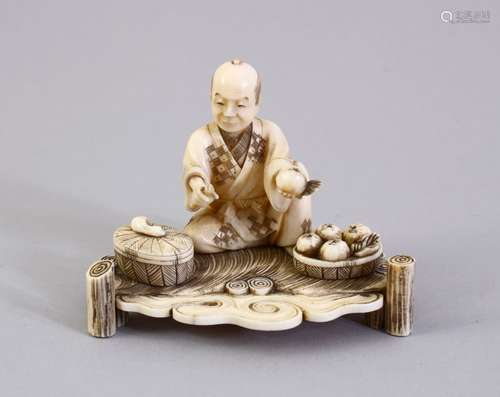 A GOOD JAPANESE MEIJI PERIOD CARVED IVORY OKIMONO, the okimono carved to depict a seated fruit