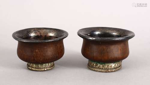 A GOOD PAIR OF 19TH CENTURY TIBETAN CARVED WOOD AND WHITE METAL WINE CUPS, both with white metal