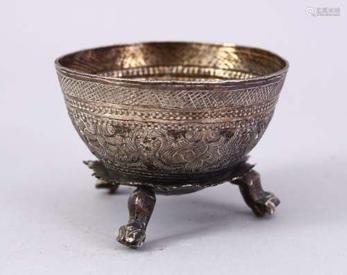 A SMALL THAI EMBOSSED SILVER BOWL, on three feet, 6cm wide.