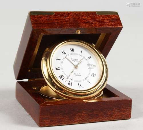 A SMALL ASPREY QUARTZ ALARM TRAVELLING CLOCK, in a wooden case. 2.25ins.