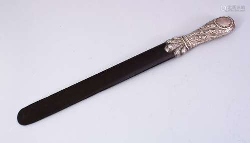 A LARGE TURKISH SILVER AND EBONY PAGE TURNER, the handle with embossed floral decoration, 44cm