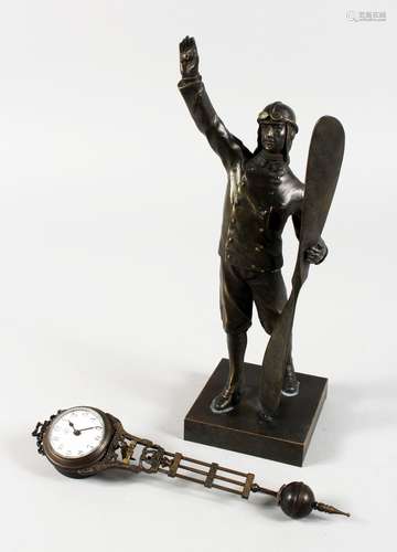 A MYSTERY CLOCK, modelled as an early pilot, standing holding a propeller. 12ins high.