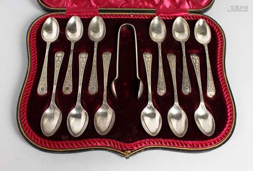 A SET OF TWELVE ENGRAVED TEASPOONS AND SUGAR TONGS in a leather case. London 1930.