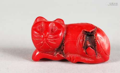 A SMALL CARVED CORAL MODEL OF A CAT. 1.25ins long.