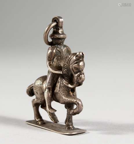 A SMALL CAST SILVER PENDANT/CHARM, modelled as a man on horseback. 1.5ins high.