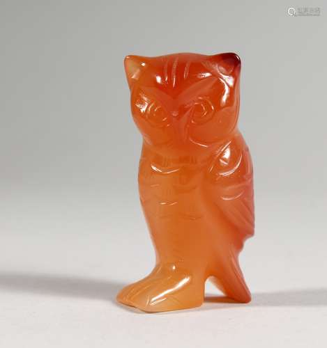 A SMALL CARVED ORANGE HARDSTONE OWL. 2ins high.