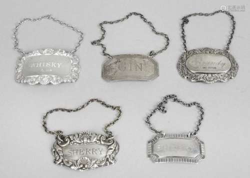 A selection of five silver wine labels,