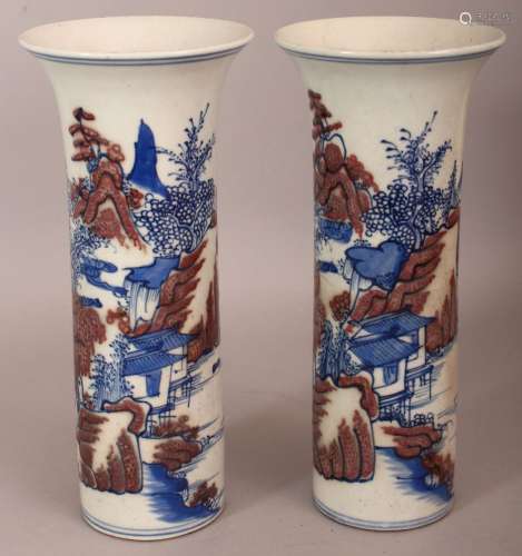 A PAIR OF CHINESE COPPER-RED & UNDERGLAZE-BLUE CYLINDRICAL PORCELAIN VASES, each decorated with a