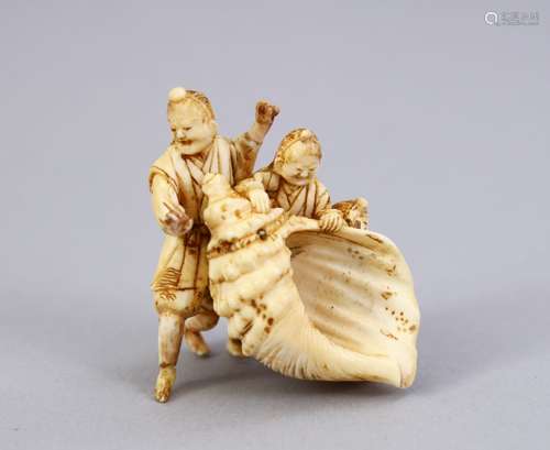 A JAPANESE MEIJI PERIOD CARVED IVORY OKIMONO - MAN & SHELL, three men stood holding a conch shell,