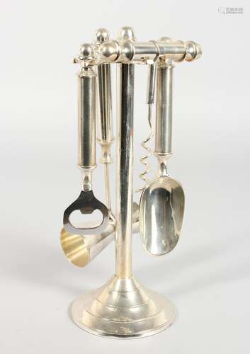 A SILVER-PLATED FOUR PIECE BAR SET on a stand.