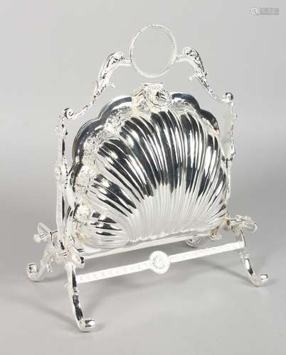 A SILVER-PLATED SHELL SHAPED MUFFIN DISH AND STAND.