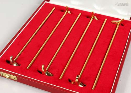 A SET OF SIX ASPREY GILT TWIZZLE STICKS, in an Asprey case.