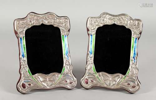 A PAIR OF ART NOUVEAU STYLE SILVER AND ENAMEL PHOTOGRAPH FRAMES, embossed with butterflies. 8ins x