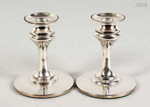 A PAIR OF SILVER DWARF CIRCULAR CANDLESTICKS, each engraved with a crest. Birmingham 1907. 4ins